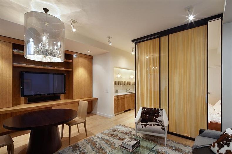 Custom-glass-wall-room-divider-with-drapes-encloses-the-bedroom